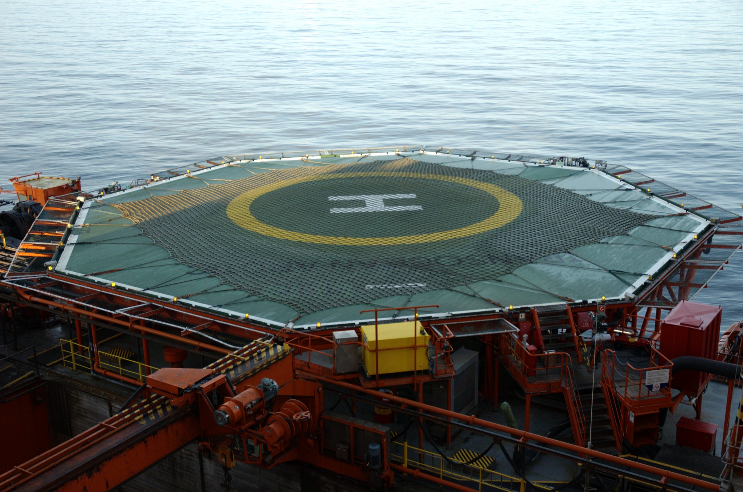 "Helideck on offshore oil rigIn order to take this picture one needs access to the rig, a work permit and allowance to bring the correct equipment. An electrician also needs to measue for gas presence and the photographer needs to carry a gas detector. Thus this pictures are rare.Sea ocean water horizon"